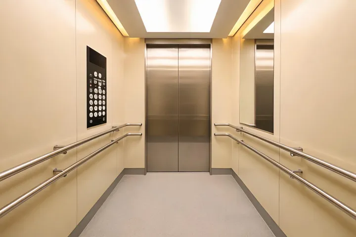 Accessible elevator cabin with clear handrails and controls