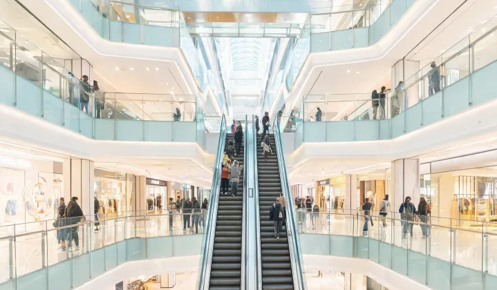 Shopping mall atrium with escalators and glass balustrades