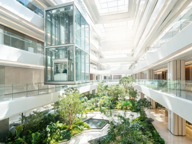 Glass elevator overlooking atrium garden