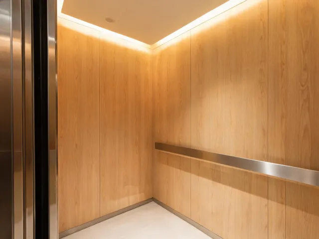 Soft-lit elevator cabin with timber accents